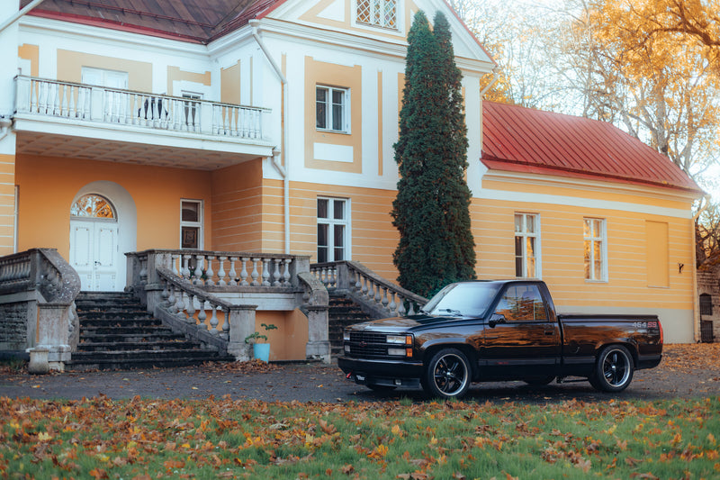 Chevrolet C1500 454 SS parked in front of a manor house